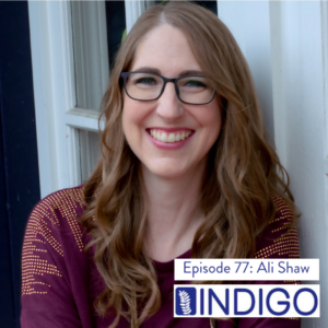 Headshot of Ali Shaw of Indigo Editing, a smiling white woman with glasses and long auburn hair